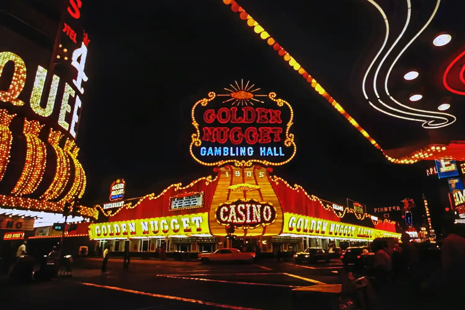 Illuminated Golden Nugget casino sign and building at night with bright neon lights